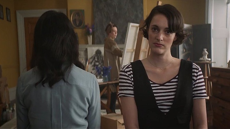 Fleabag looks into the camera in the middle of an art class in Fleabag.