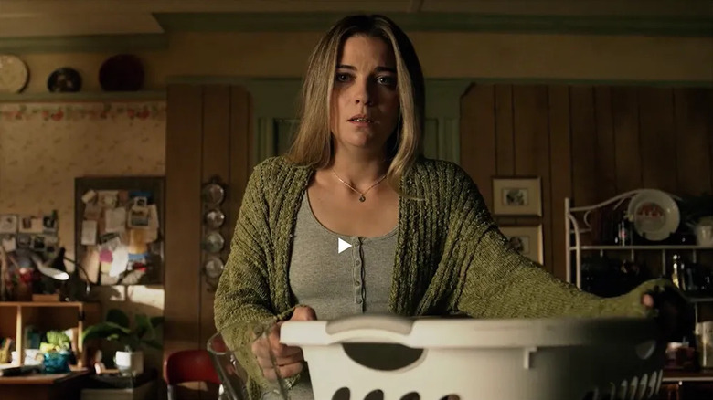 Allison looks upset while handling a bin of laundry in Kevin Can F*** Himself.