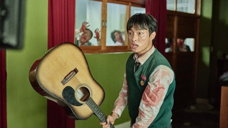 Cheong-san brandishes a guitar on "All of Us Are Dead" (2022-present)