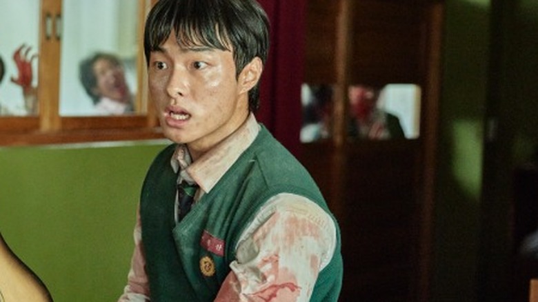 Cheong-san brandishes a guitar on "All of Us Are Dead" (2022-present)