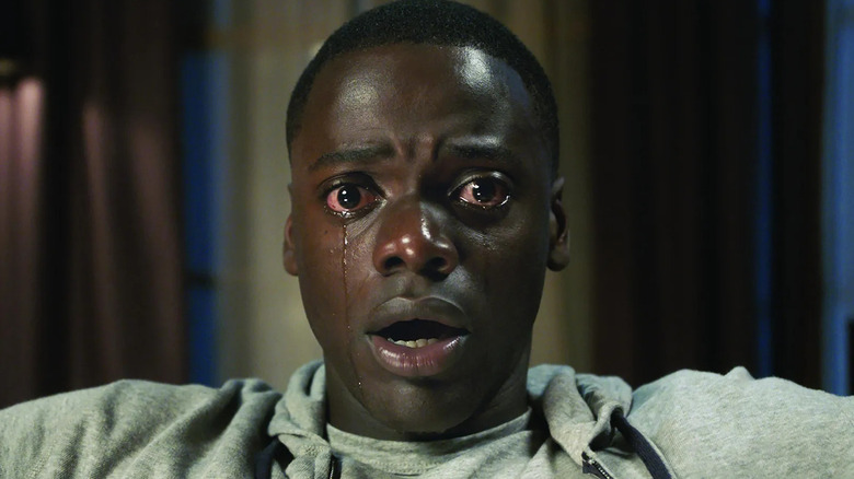 Chris trapped in the chair crying with his eyes wide in Get Out