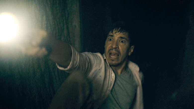 AJ screaming and holding a flashlight in Barbarian