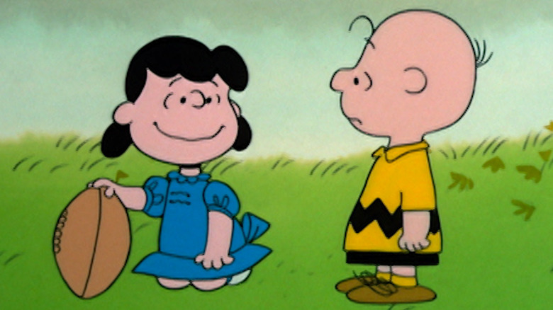 Lucy holds the football for Charlie Brown