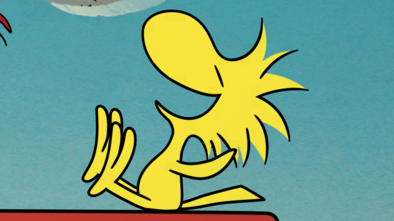 Woodstock on Snoopy's house laughing