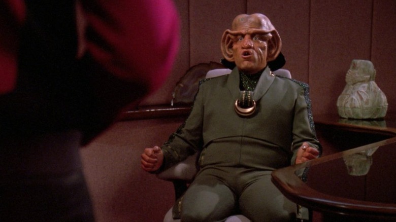 Daimon Bok sits in the captain's chair in Star Trek: The Next Generation
