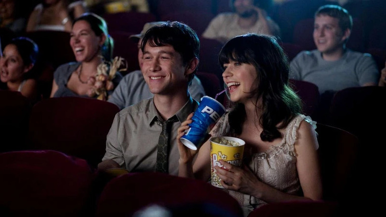 Tom and Summer laughing watching a movie in (500) Days of Summer