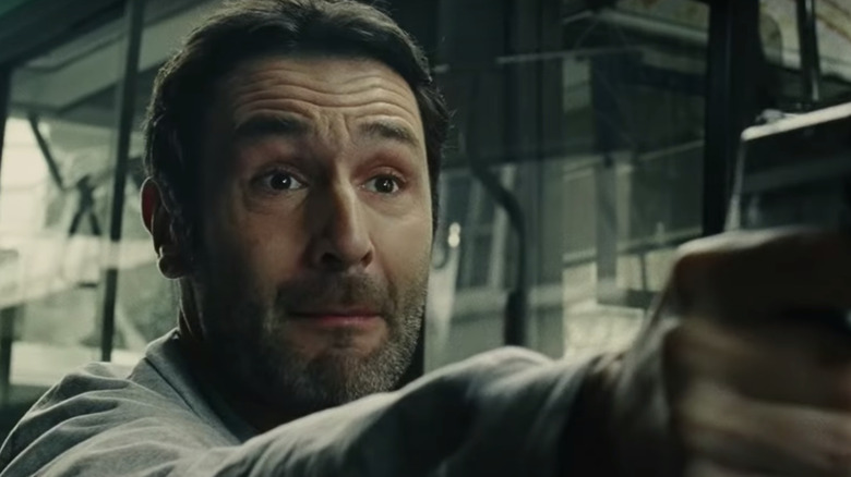 Gilles Lellouche aiming gun