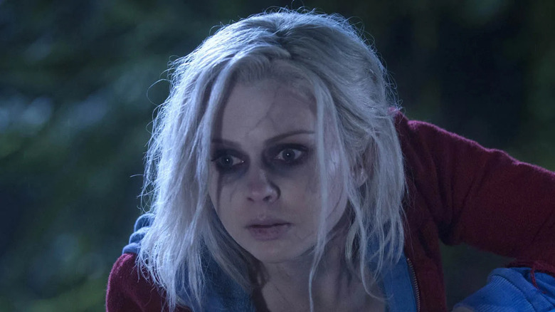 A wide-eyed Liz crouches down