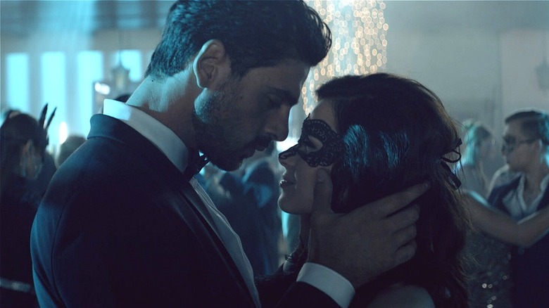 Massimo and Laura dancing at masquerade party in 