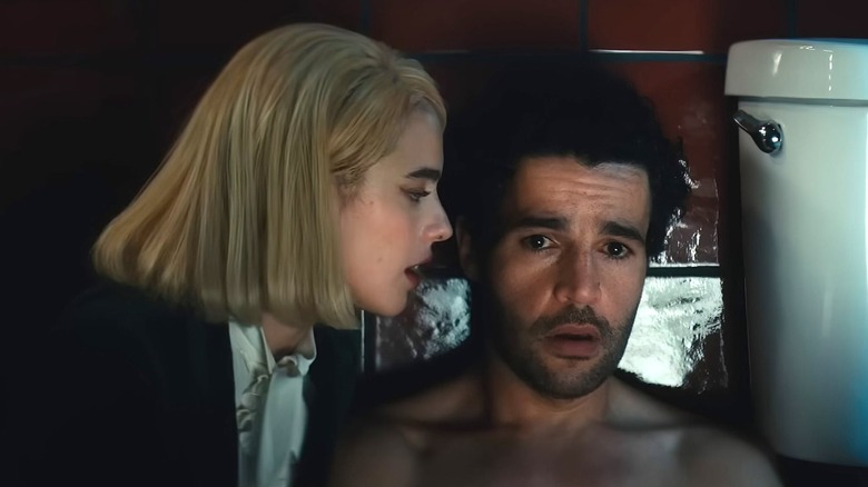 Rebecca whispers in Christopher's ear in "Sanctuary" (2022)