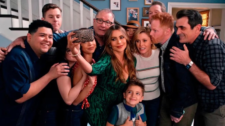 The family taking a selfie on Gloria's phone in 