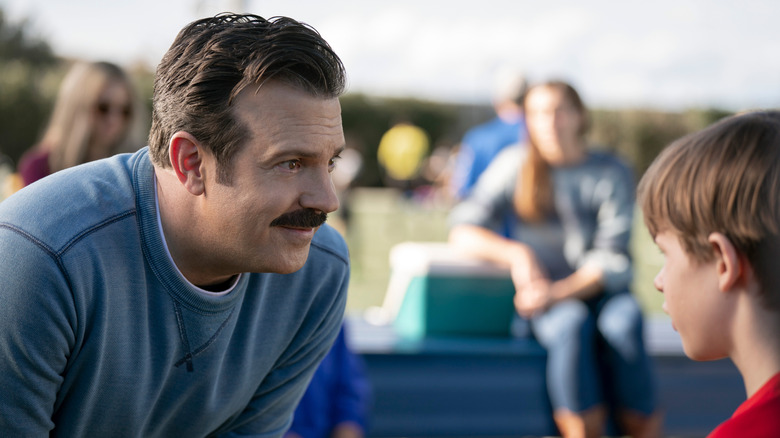 Ted speaking to a child in "Ted Lasso."