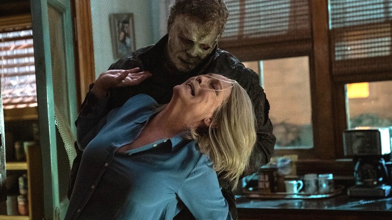 Michael Meyers holding Laurie in "Halloween Ends"