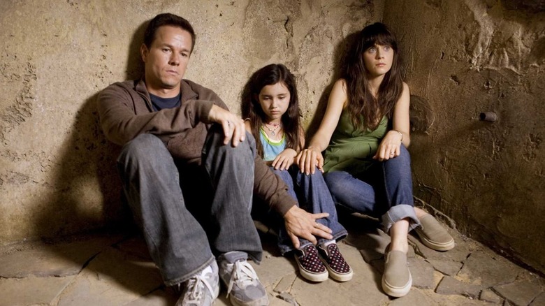 Elliot, Jess, and Alma sitting on the ground in 