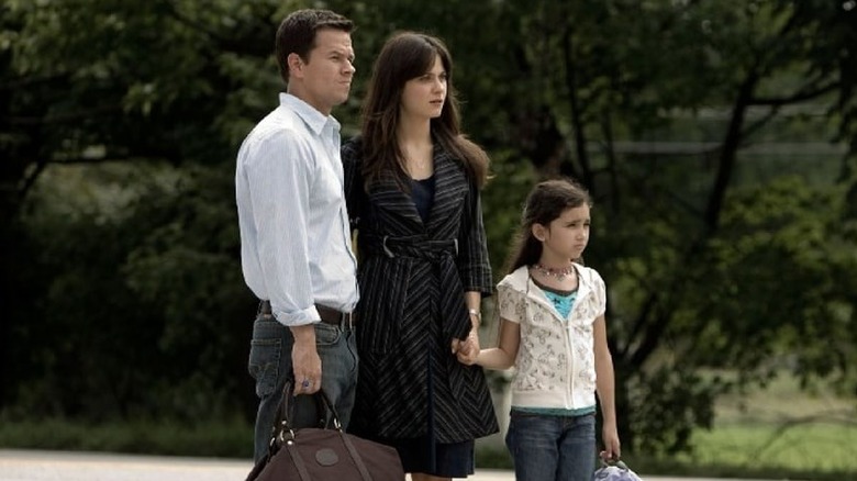 Elliot, Alma, and Jess standing in the road in "The Happening"