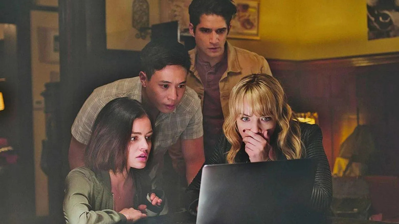 Four people grouped around a laptop in "Truth or Dare"