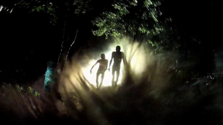 Aliens walking among trees in the dark in "V/H/S/2"
