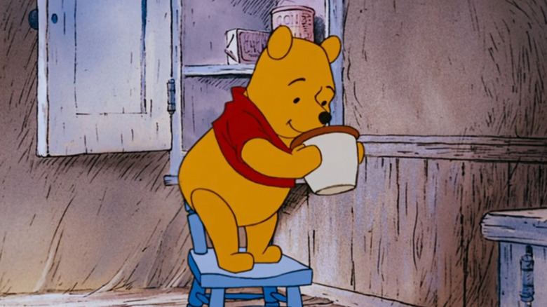 Winnie-the-Pooh looking at an empty jar in "The Many Adventures of Winnie the Pooh" (1977)