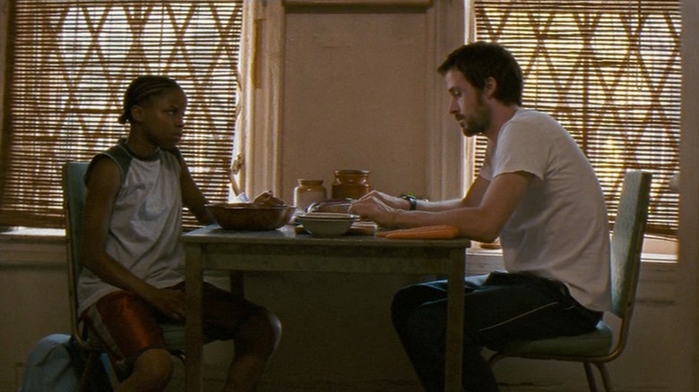 Dan Dunne sitting with a student
