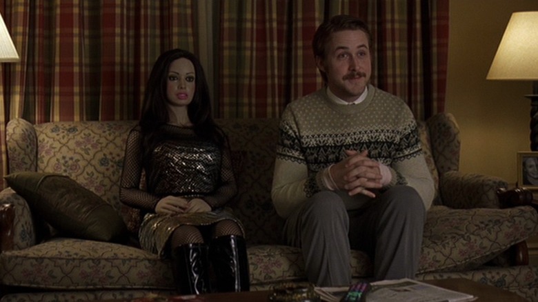 Lars sitting on the sofa with his doll girlfriend