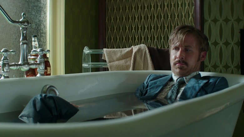 Holland March in a bathtub wearing a suit