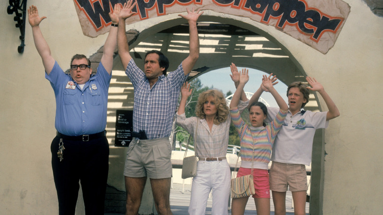 The Griswolds and a security guard are pinned down by cops in "National Lampoon's Vacation"
