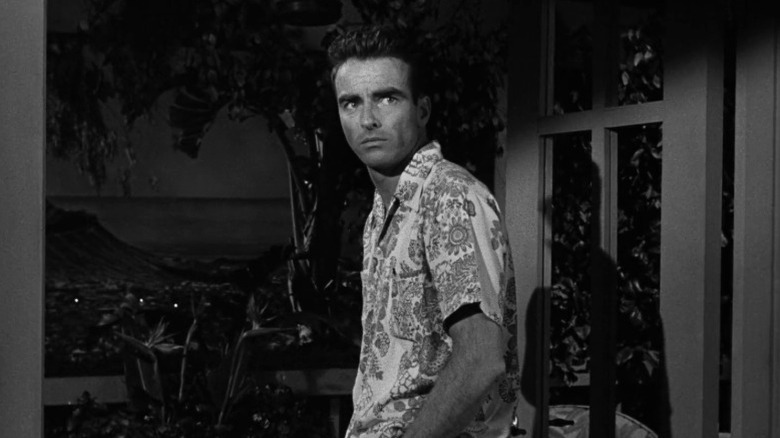 Robert E. Lee Prewitt standing by a door in From Here to Eternity
