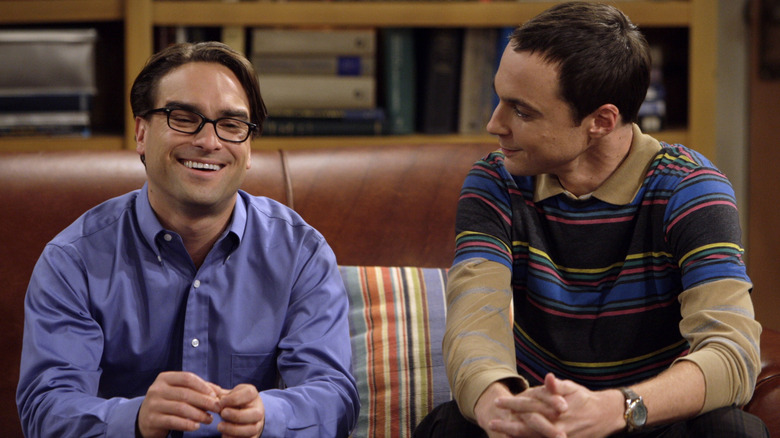 Leonard and Sheldon sitting on the couch smiling in 