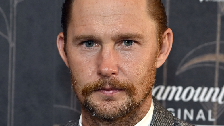 Brian Geraghty posing on red carpet at the 1923 premiere