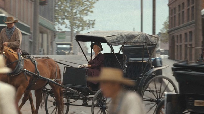 Cara Dutton riding into town 