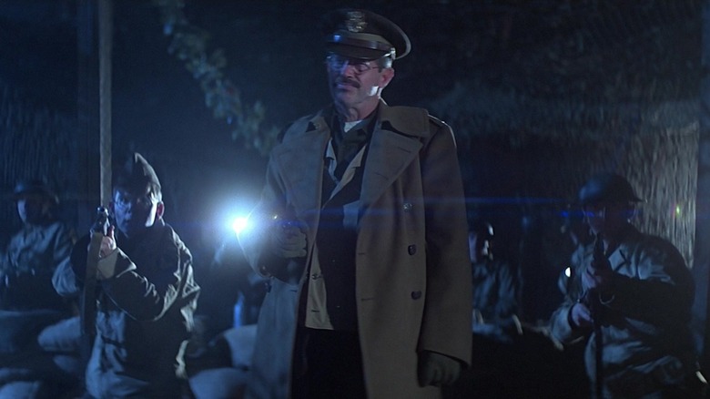 Warren Oates holding gun