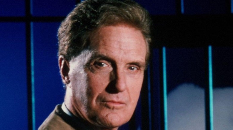 Robert Stack in front of bars