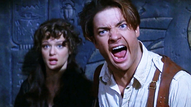 Rick O'Connell and Evelyn Carnahan backed against a wall in "The Mummy" (1999)