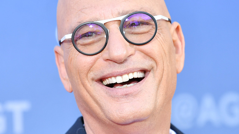 Howie Mandell smiling with glasses