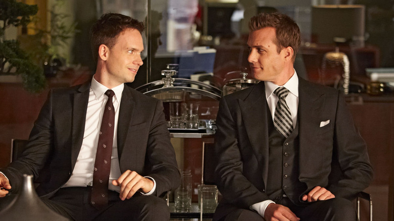 Harvey Spectre and Mike Ross sitting next to each other in office