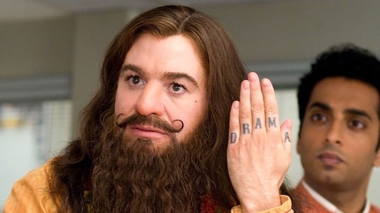 The Guru Pitka showing off his finger tattoos in "The Love Guru"