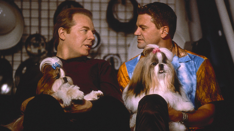 Scott and Steffan looking at each other holding dogs in "Best in Show" (2000)