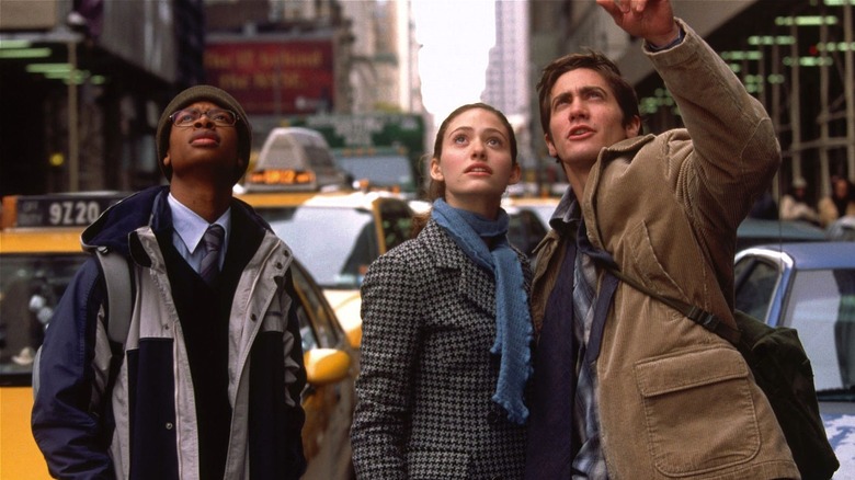 Brian, Sam, and Laura standing in NYC street looking up