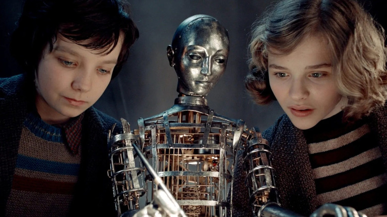 Hugo and Isabelle watching the machine write in 
