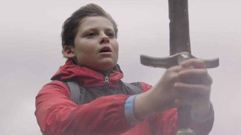 Alex holding his sword, surrounded by smoke, in "The Kid Who Would Be King."