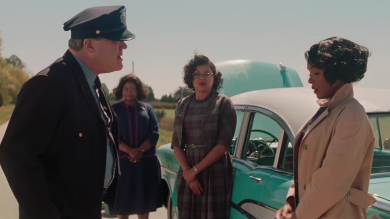 A police officer talks to Mary as Dorothy and Katherine look on in "Hidden Figures"