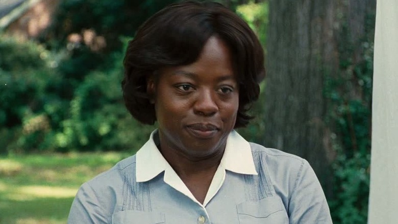 Aibileen standing outside smiling in "The Help"