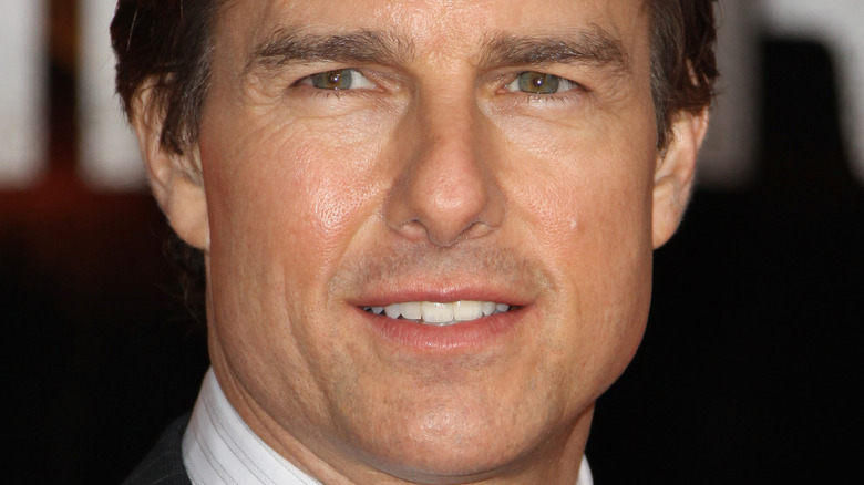 Tom Cruise with a feint smile 