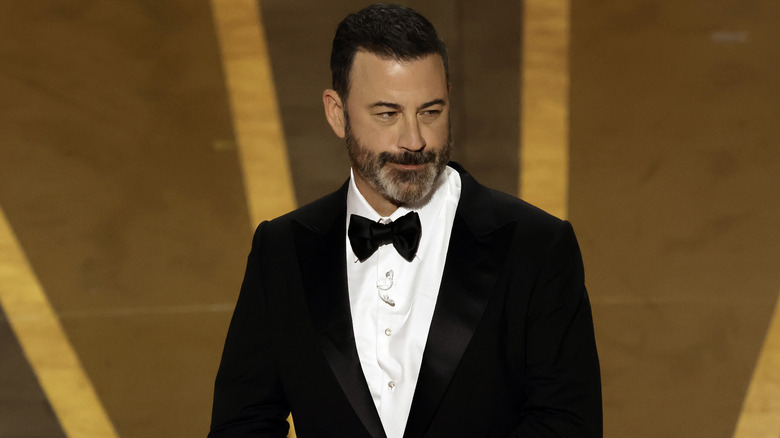 Jimmy Kimmel in suit Oscars stage