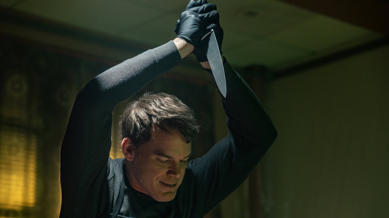 Dexter holding a butcher's knife over his head
