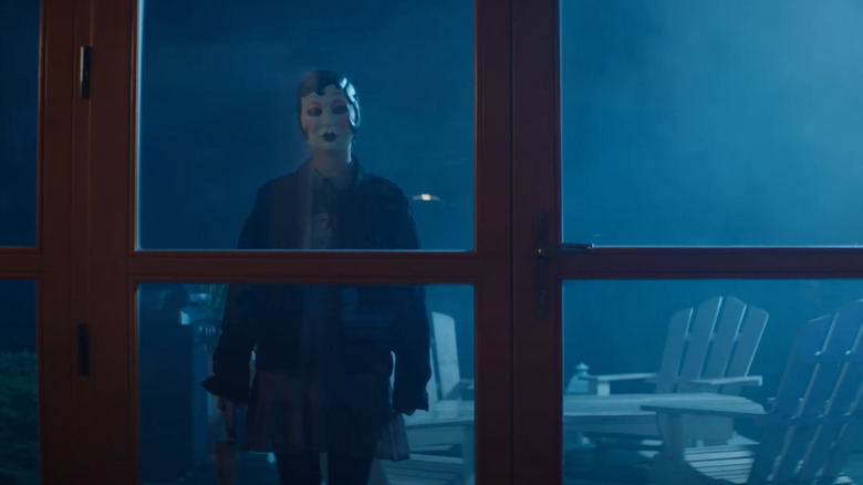 Dollface staring through a window in The Strangers: Chapter 2 (2025)