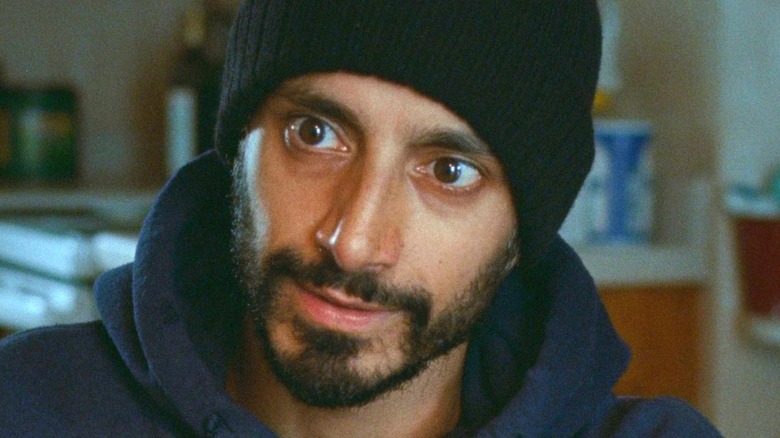 Riz Ahmed looks on