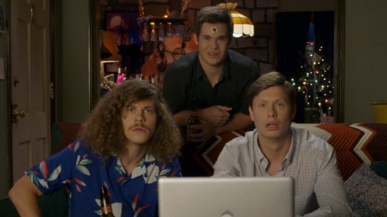 The guys stare at a computer 