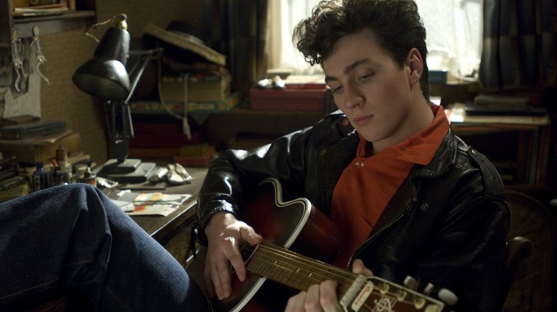 Lennon practices guitar