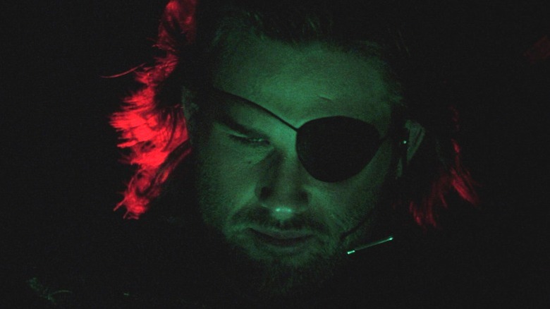 Kurt Russell looking down
